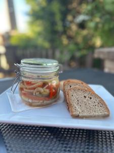a jar of pickles and a slice of bread at Restaurace-Penzion U Pilota in Kněževes