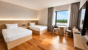 a hotel room with a bed and a desk at H&H Boutique Hotel in Cukai