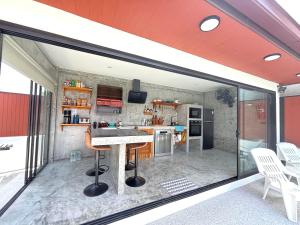 a kitchen with a table and chairs in a room at Big leaf villa kohsamui in Bangrak Beach