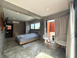 a bedroom with a bed and two chairs in it at Big leaf villa kohsamui in Bangrak Beach +40 photos