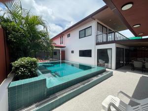 a swimming pool in the backyard of a house at Big leaf villa kohsamui in Bangrak Beach