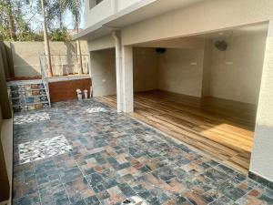 an empty house with a tile floor and a porch at Tropical Haven in Panaji