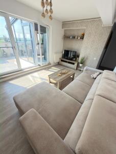 a living room with a couch and a table at Cajara Home in Bucharest