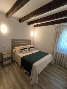 a bedroom with a large bed and a window at Casa Fontenlos in Tui +13 photos