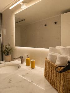 a bathroom with a sink and a mirror at Noéma Mani Boutique Residences in Gythio