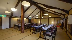 a dining room with tables and chairs and lights at Ryori Ryokan Tsurugata in Kurashiki +95 photos