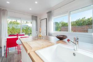 a kitchen with a sink and a large window at Villa by the sea - in full relaxation - Air conditioned - Wi-fi in Fontane Bianche +14 photos