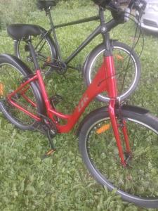 a red bike parked on the grass at Alberta Dīķi in Upesciems +26 photos