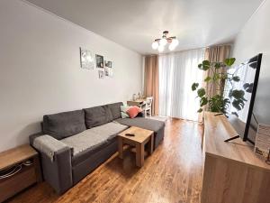 a living room with a couch and a table at Kosenko apartments in Zhytomyr