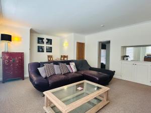 a living room with a couch and a coffee table at Benson House Box in Box +17 photos