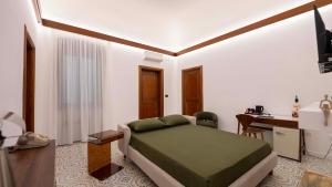 a bedroom with a bed and a desk and a table at The Suite - Trani centro in Trani