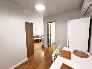 a dining room with a white table and chairs at Kosenko apartments in Zhytomyr +14 photos
