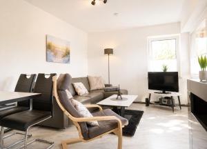 a living room with a couch and a table at Terrassenhaus Whg 21 in Duhnen