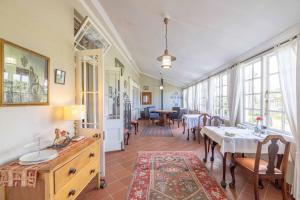 a dining room with a table and chairs and windows at Kingston Farm in Bathurst