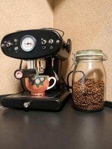 a coffee maker and a jar of coffee beans at Quiet and charming studio apartment in Vejle