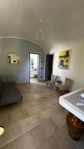 a living room with a couch and a table and chairs at Masseria Trullo Sovrano Exclusive B&B in Cisternino