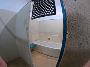 a bathroom with a bath tub and a sink at 1849 Backpackers at The London in Albany +190 photos