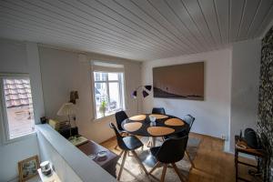 a living room with a table and chairs and a couch at Auntie Laurentze's house in Haugesund
