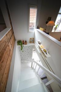 a white staircase in a house with a window at Auntie Laurentze's house in Haugesund +16 photos