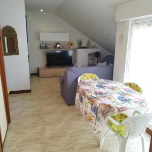 a living room with a table and chairs and a couch at Atico en Ajo Cantabria in Ajo