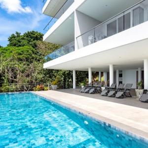 a swimming pool in front of a house at Mountain and Sea view apartment in Nathon Bay