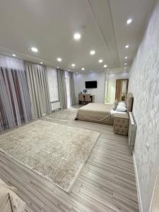 a bedroom with a bed and a television in it at Comfort Hotel in Türkistan