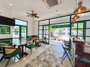 a dining room with tables and chairs and windows at MARINA SEASIDE BEACH BOUTIQUE Phu Quoc - Infinity Pools - PREMIUM SOLAR ENERGY in Phú Quốc