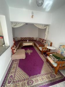 a living room with a purple rug on the floor at بيت الضيافه و الترحيب in Azrou