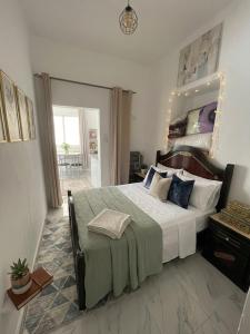 a bedroom with a large bed with a large mirror at بيت الضيافه و الترحيب in Azrou