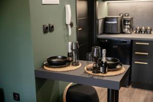 a kitchen with a table with pots and pans on it at Skyline suite studio in Larisa