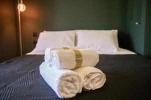 a pile of towels sitting on top of a bed at Skyline suite studio in Larisa