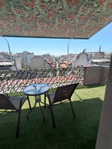 a table and two chairs on a roof at Skyline suite studio in Larisa