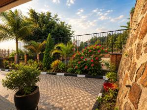 a courtyard with a bunch of flowers and plants at The Gathering in Kigali +6 photos