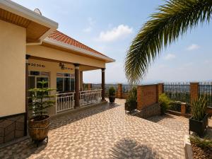 a patio of a house with a palm tree at The Gathering in Kigali