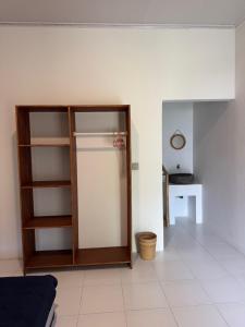 a living room with a glass cabinet and a table at JHOB Surf Stay in Maluk +35 photos