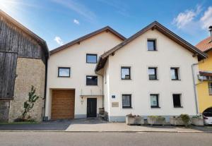 a white house with a garage at Haus Kathrein in Prutz
