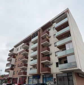 a building with balconies on the side of it at Apartman 14 in Doboj