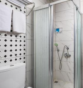 a shower with a glass door in a bathroom at Sultanahmet Nu Hotel in Istanbul +41 photos