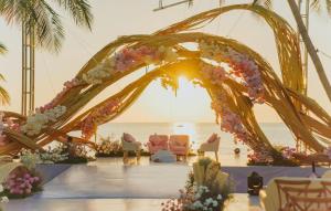 a wedding arch with chairs and flowers on the beach at MARINA SEASIDE BEACH BOUTIQUE Phu Quoc - Infinity Pools - PREMIUM SOLAR ENERGY in Phú Quốc +158 photos