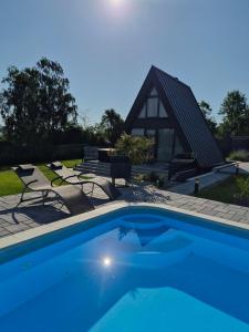 a swimming pool in front of a house at Nikis House Luxury Pool - Spa Villa in Ba°evac