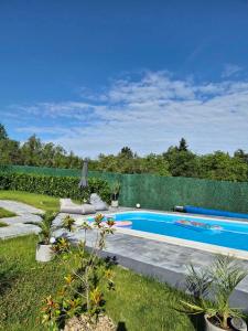 a swimming pool in a yard with plants at Nikis House Luxury Pool - Spa Villa in Ba°evac