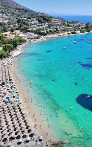 a beach with a bunch of people in the water at Hera's apartment in Porto Rafti +8 photos