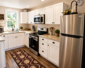 a kitchen with white cabinets and a stainless steel refrigerator at Pride House in Providence