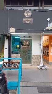 a store front with a blue bench in front of it at VKB Ferringhi Styles Penang formerly Grand Star Hotel in Batu Ferringhi