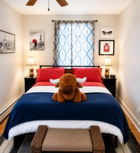 a teddy bear sitting on top of a bed at Pride House in Providence