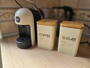 two coffee cups and a coffee maker on a counter at Apartmani Vlaovic in Herceg-Novi