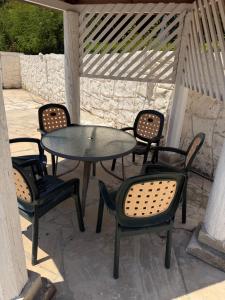 a table and chairs sitting on a patio at villa 58 coral bay seafront in Peyia