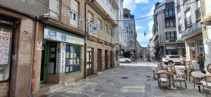 a street with chairs and tables on a city street at Apartamento Ático Select Real Caldas de Reis in Caldas de Reis