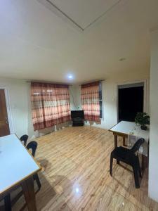an empty room with two tables and chairs in it at Ezzy Air B&B in Salelologa