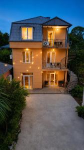 a large house with stairs leading up to it at Guest House Leon in Batumi